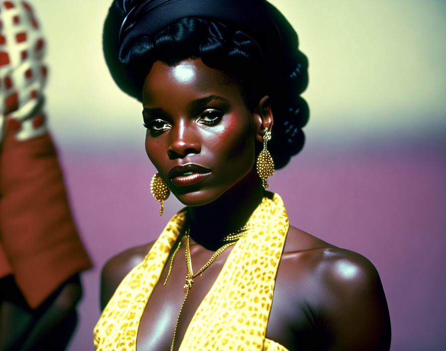 Dark-skinned woman in yellow scarf and gold jewelry against gradient backdrop