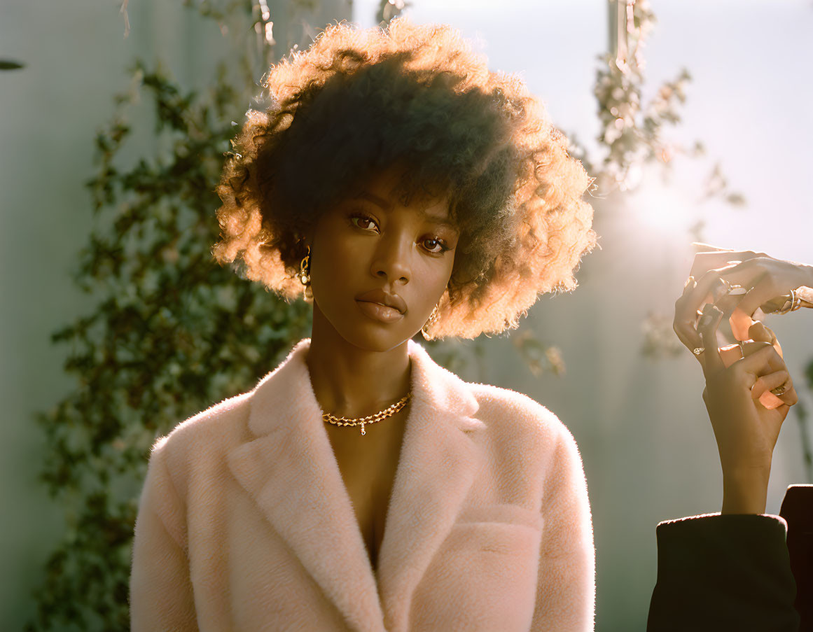 Curly Afro Woman in Pink Coat and Gold Necklace