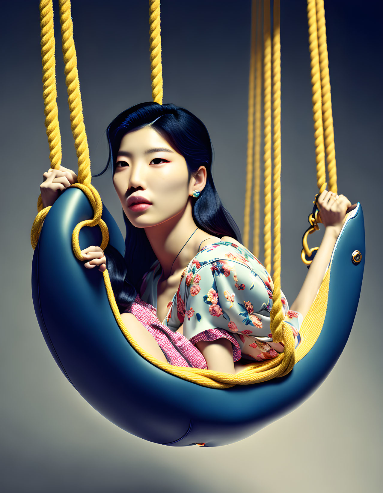 Woman in floral top on whimsical swing against neutral background