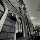 Intricate architecture with arched windows and mountain backdrop