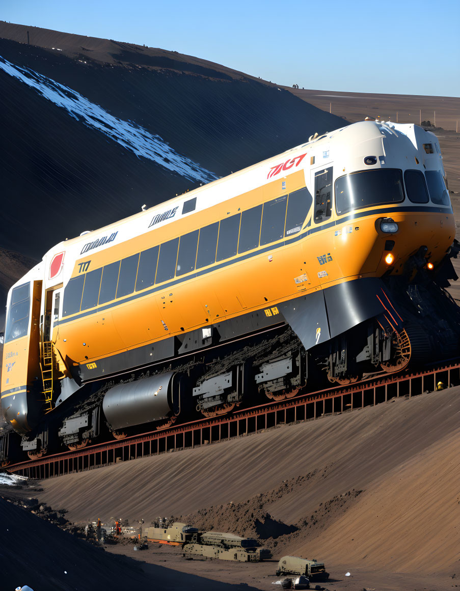 Vintage yellow and white train with Chinese characters on sandy dune under blue sky