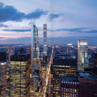 City skyline at dusk with illuminated skyscrapers under blue twilight sky