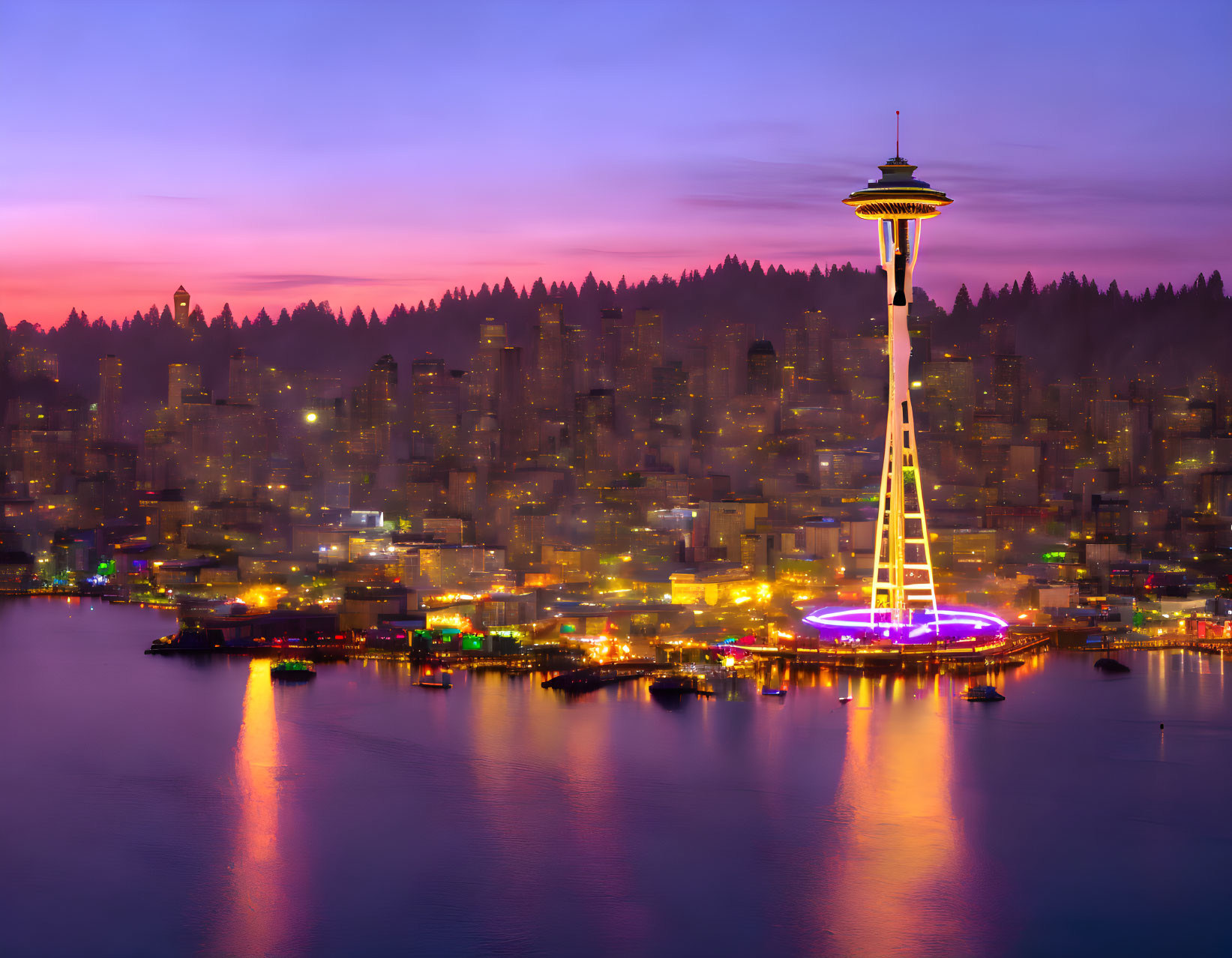 City skyline with needle-like tower, lit waterfront, and forested hill at twilight