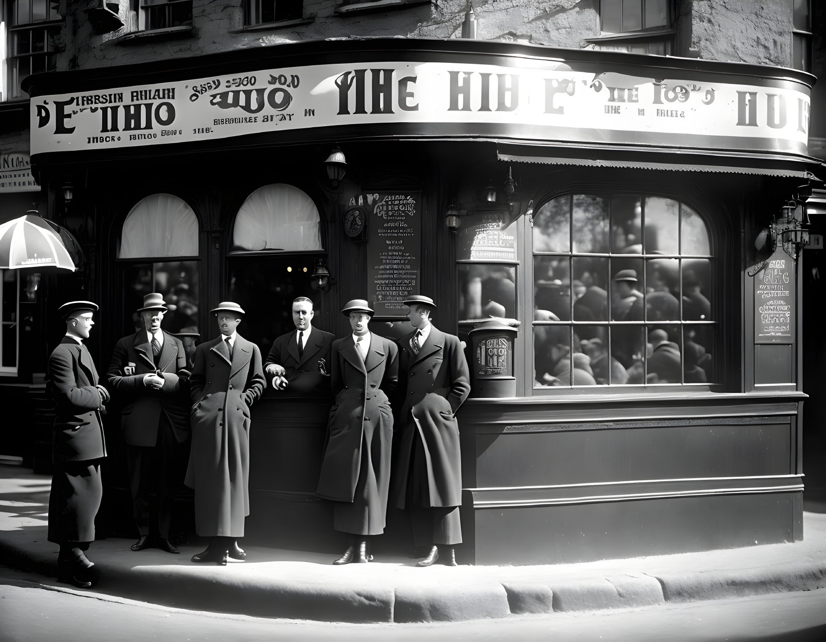 Vintage black and white photo of seven men in front of ornate pub signage