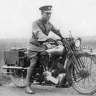 Vintage-clad man on old motorcycle in foggy desert landscape