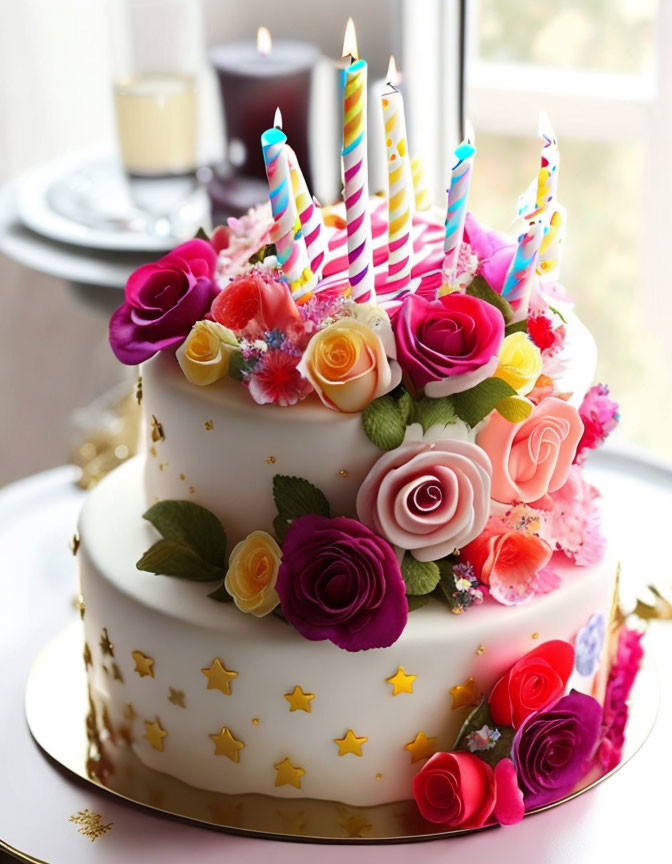 Colorful Candle Birthday Cake with Edible Flowers on White Stand