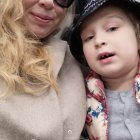 Woman and girl in sunglasses and hoodie gazing upwards