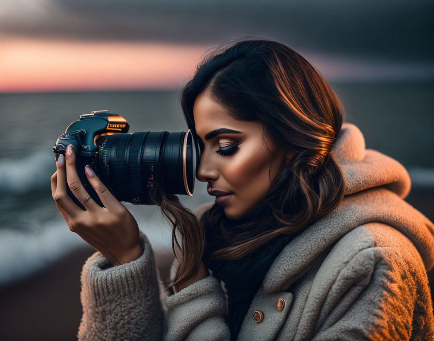 Woman with Long Hair Capturing Photo at Twilight Ocean