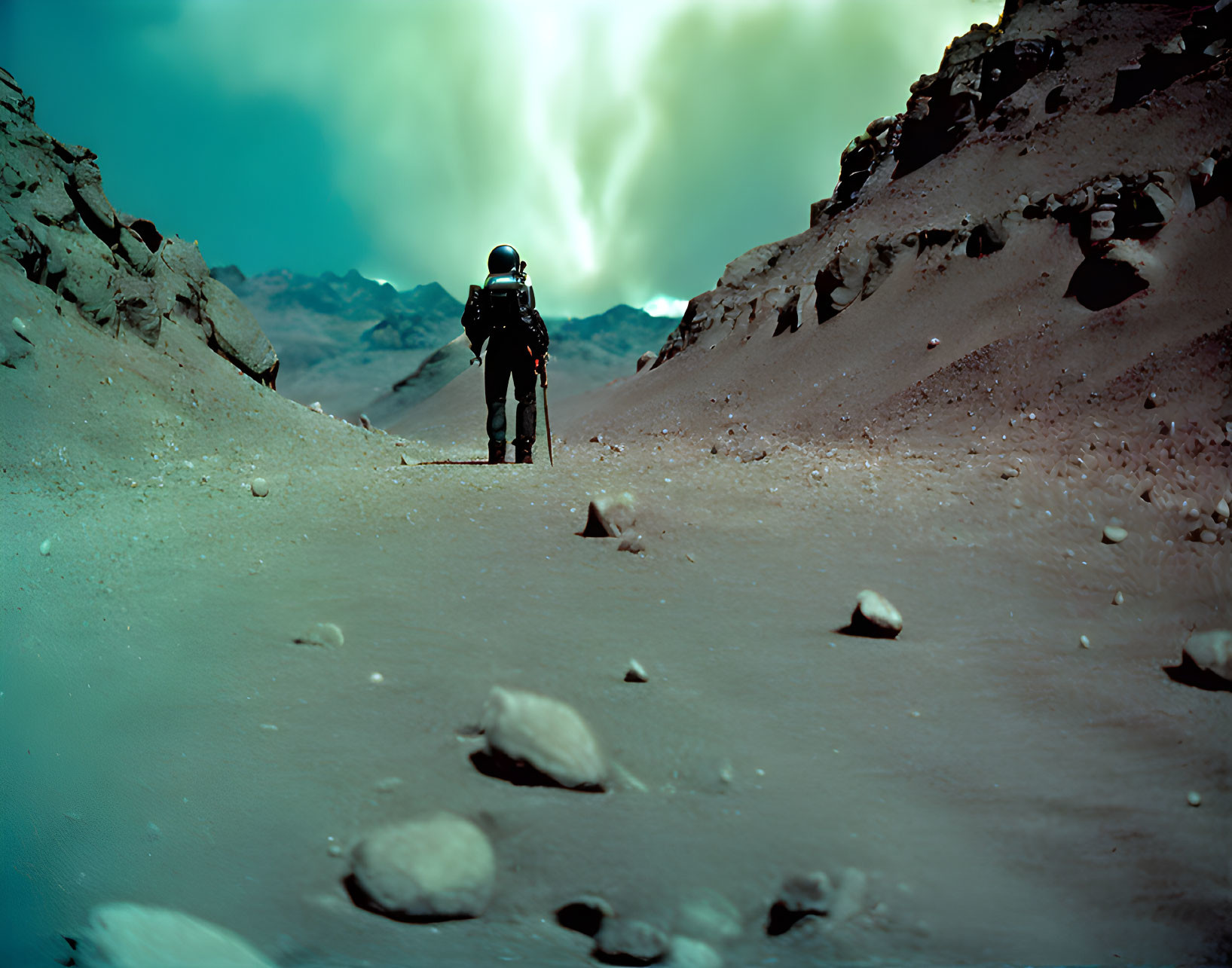 Astronaut on rocky surface with mountains under turquoise sky