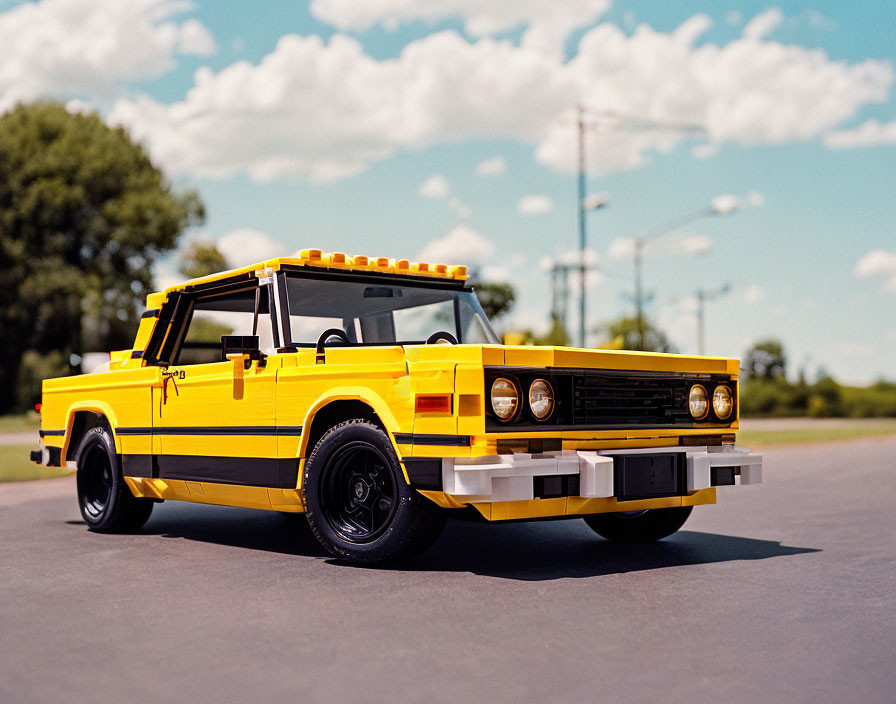 Yellow and Black Vintage LEGO Car Model on Road with Blue Sky