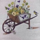 Wooden wheelbarrow with colorful flowers on pastel background