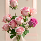 Pink tulips bouquet with water droplets, fallen petals, and clear vase on sunlit table