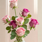 Pink and Magenta Roses in Vase Against Beige Background