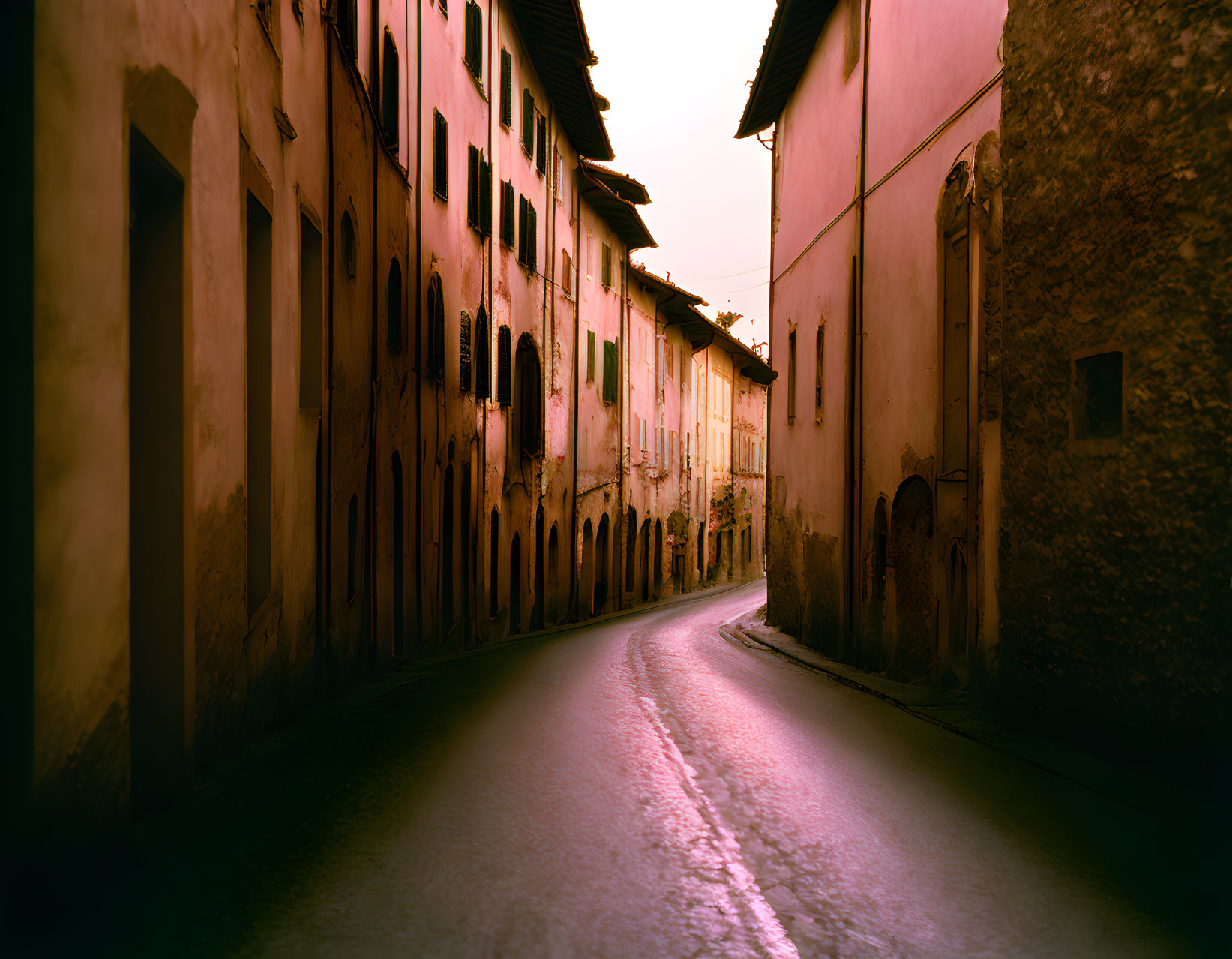 Old Weathered Buildings on Cobblestone Street at Dusk