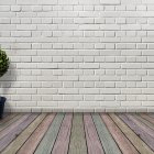 Wooden floor with eye design, brick wall, and potted plant in interior setting