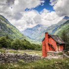 Curved wooden houses in forest landscape with dramatic sky