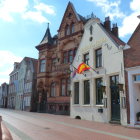 Colorful Houses and Café on Vibrant Cobblestone Street