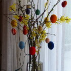 Colorful Easter Egg Arrangement with Blooming Branches in Clear Vase