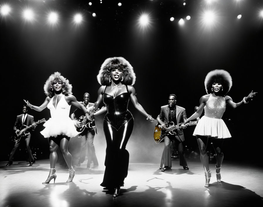 Musical stage show with spirited female performers in glamorous black-and-white costumes