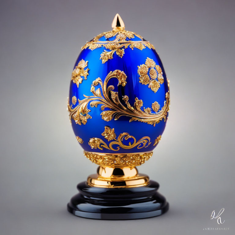 Intricate Gold Detailing on Royal Blue Fabergé Egg Displayed on Black Pedestal