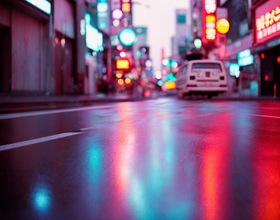 Wet City Street at Dusk with Neon Signs and Car