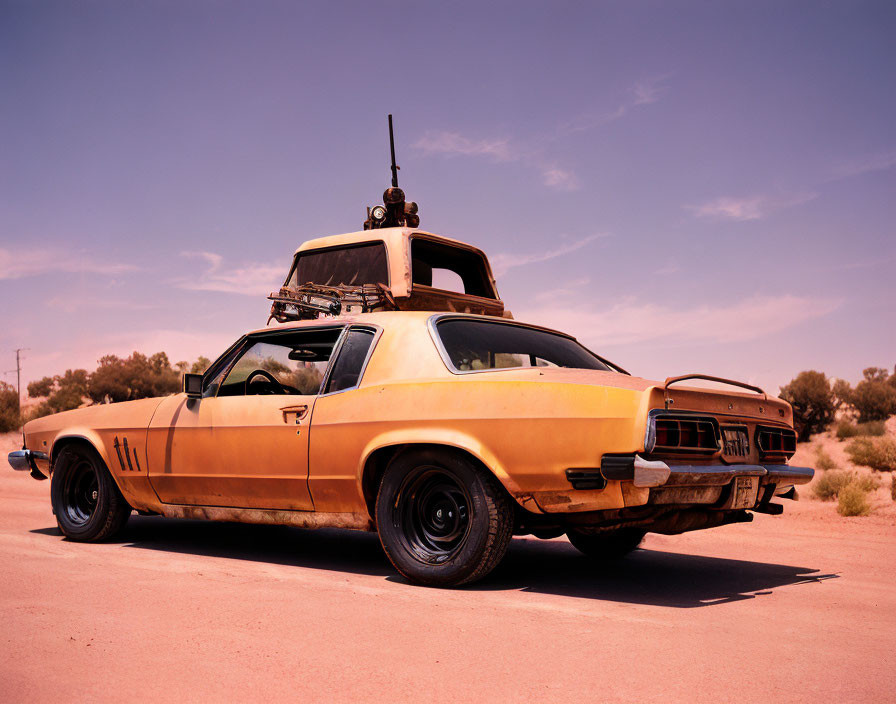 Vintage Yellow Muscle Car with Black Trim Parked in Desert Road