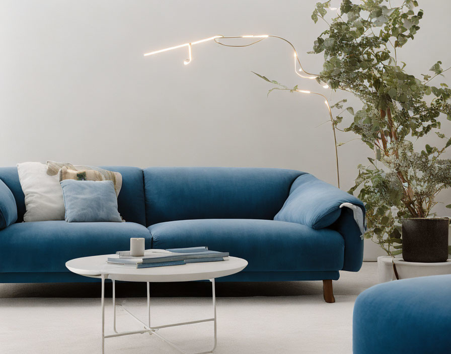 Minimalist Living Room with Blue Sofa, White Coffee Table, LED Light, and Potted Plant