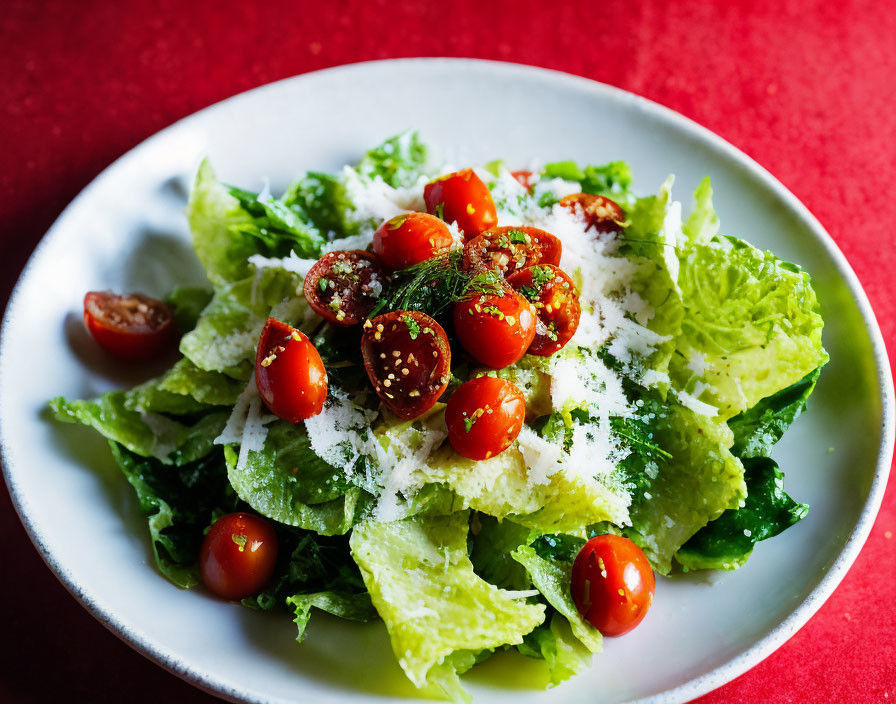 Fresh Caesar Salad with Romaine Lettuce and Parmesan Cheese on White Plate