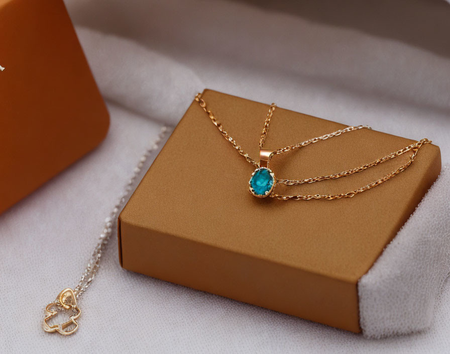 Turquoise Pendant on Gold Necklace in Brown Jewelry Box with Butterfly Charm