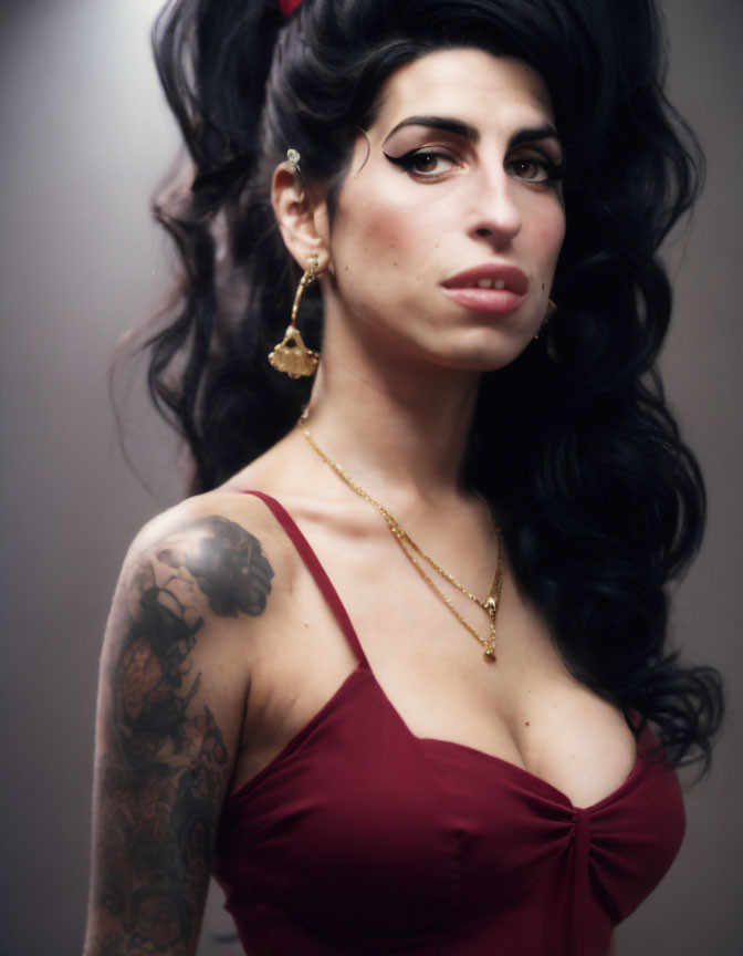 Person with Voluminous Black Hair, Winged Eyeliner, Tattoos in Red Attire