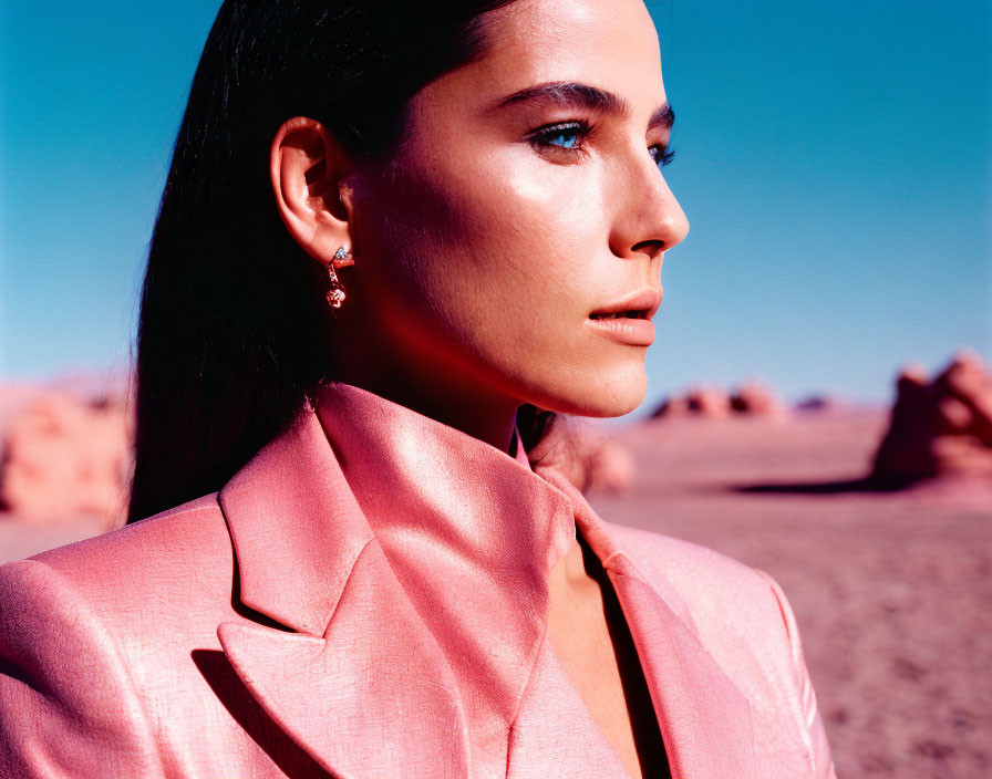 Woman in Pink Blazer Against Desert Landscape in Vivid Colors