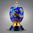 Intricate Gold Detailing on Royal Blue Fabergé Egg Displayed on Black Pedestal