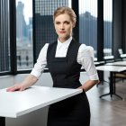 Blond woman in black apron at modern restaurant