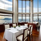 Sophisticated Restaurant Interior with Sea View and Set Tables