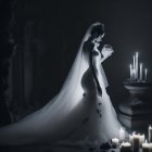 Bride in white gown holding a skull in dimly lit room