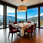 Elegant dining room with set table, mountain views, and pendant light