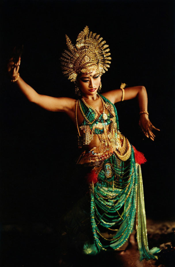 Elaborate Golden Headdress and Green Costume in Dramatic Pose