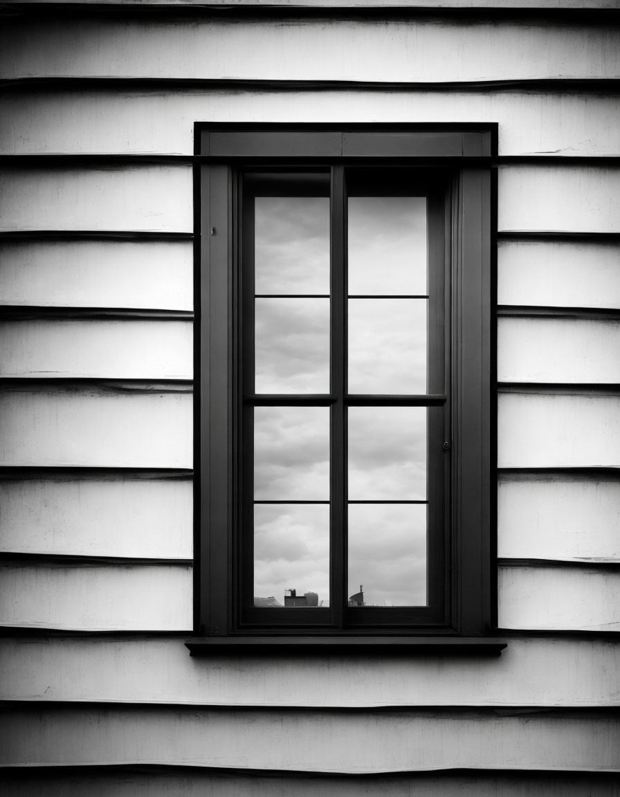 Monochrome photo: Closed square window on striped building facade