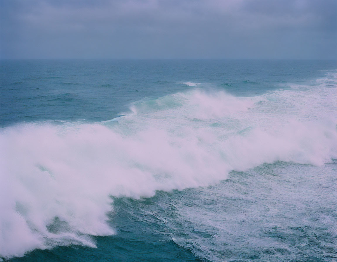 Tranquil seascape with rolling waves under overcast sky