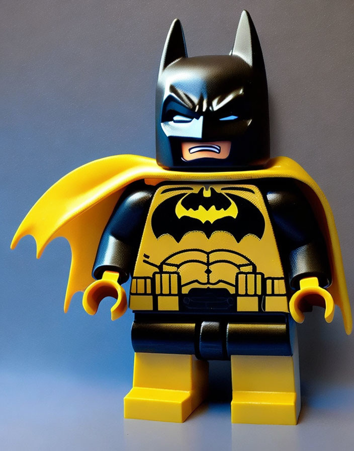 Batman Lego Figure in Black and Yellow Suit on Blue Background