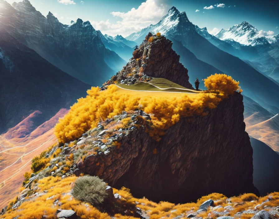 Vibrant yellow tree on picturesque mountain peak amid jagged mountains