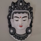 Serene multi-faced deity with elaborate headdress and jewelry