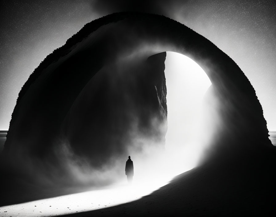 Person's silhouette in sand dunes under large mystical arch