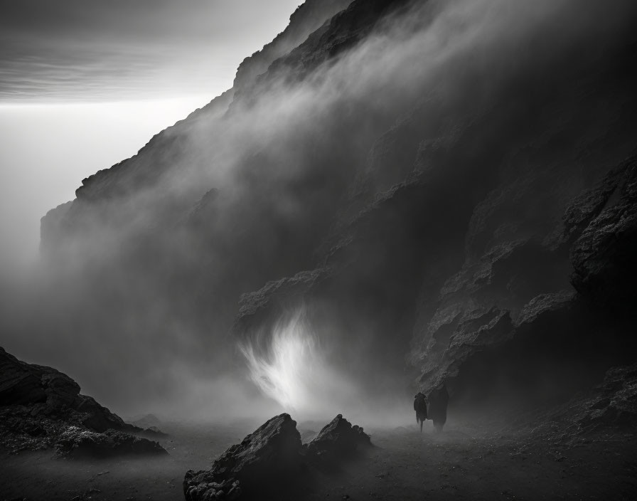 Figure in misty rugged landscape with soft light.