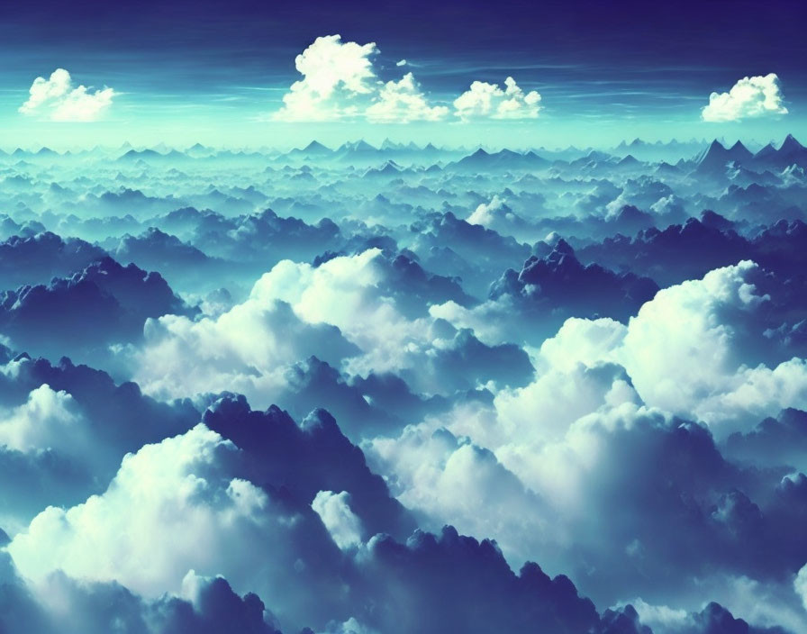 Fluffy white clouds over misty mountainous terrain