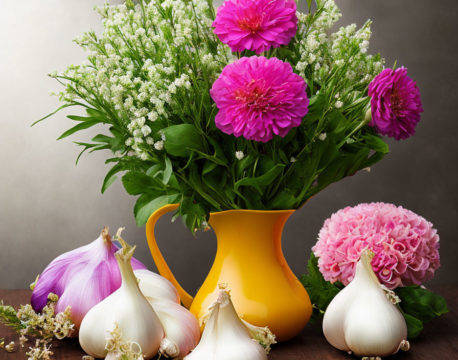 Pink Flowers Bouquet with Baby's Breath in Yellow Vase and Fresh Garlic Bulbs on Wooden Surface