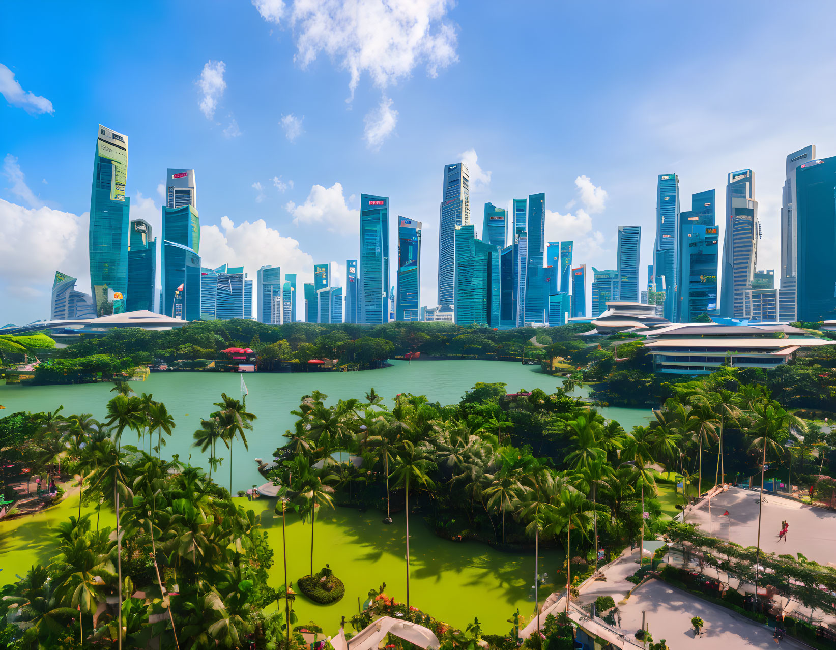 Modern City Skyline with Skyscrapers, Greenery, and Waterfront Panorama