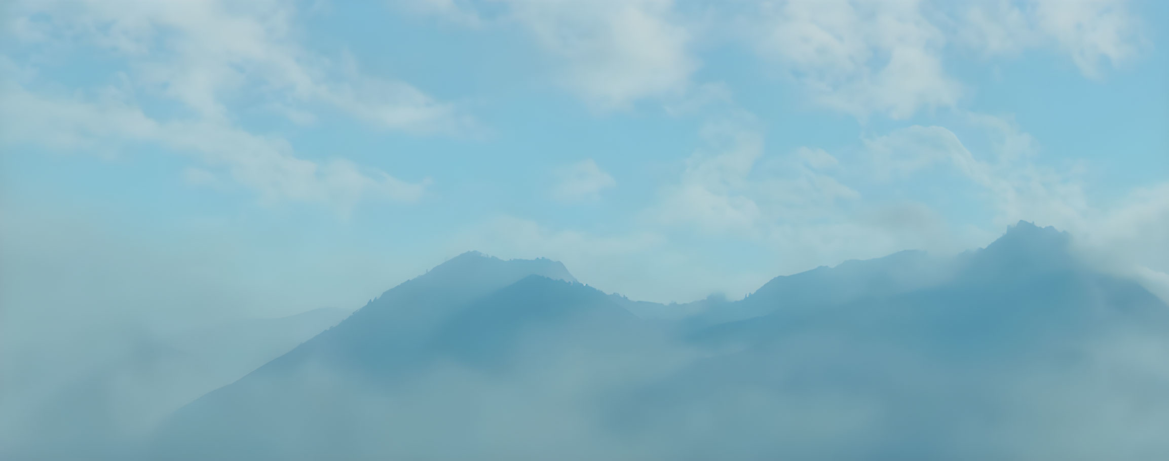 Misty Mountains under Soft Blue Sky