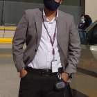 Blonde man in blue mask and pirate outfit on ship deck with clouds