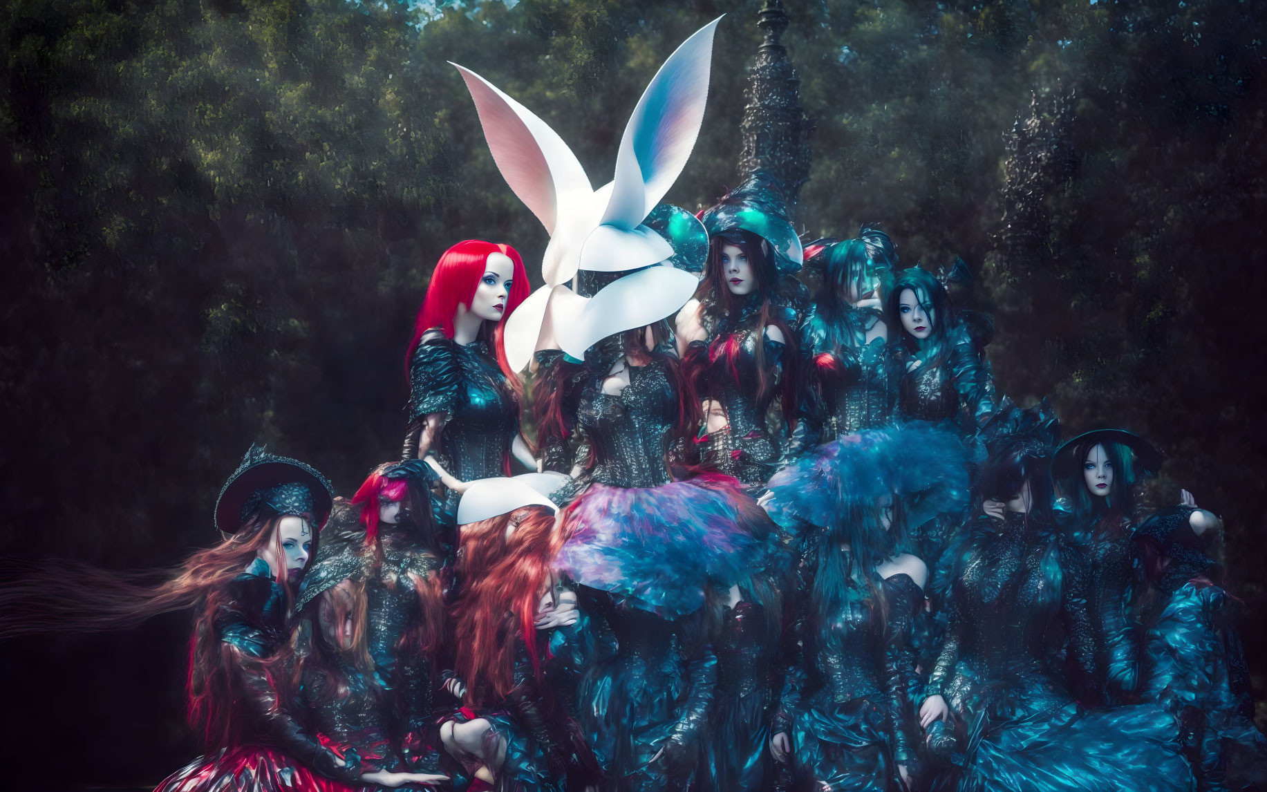 Group of individuals in vibrant fantasy costumes posing in mystical forest